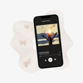 Phone displaying a music app with a song playing on a light background
