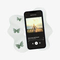 Phone displaying a meditation app with butterflies and a scenic background